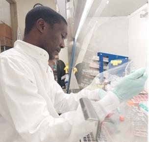 Tonny Owalla working in the lab