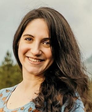 Headshot of DGH faculty Julianne Meisner wearing a light blue long sleeve with orange flowers.