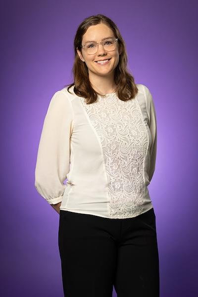 Morgan Aurelio wears business casual clothing and smiles at the camera.