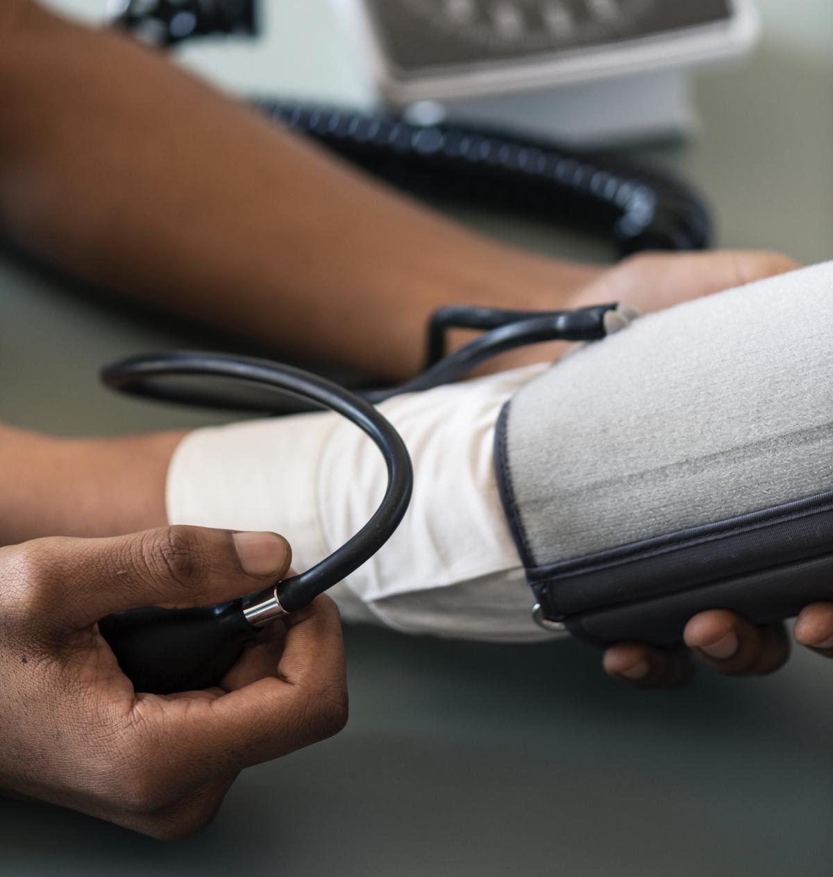 Nurse taking someones blood pressure. 